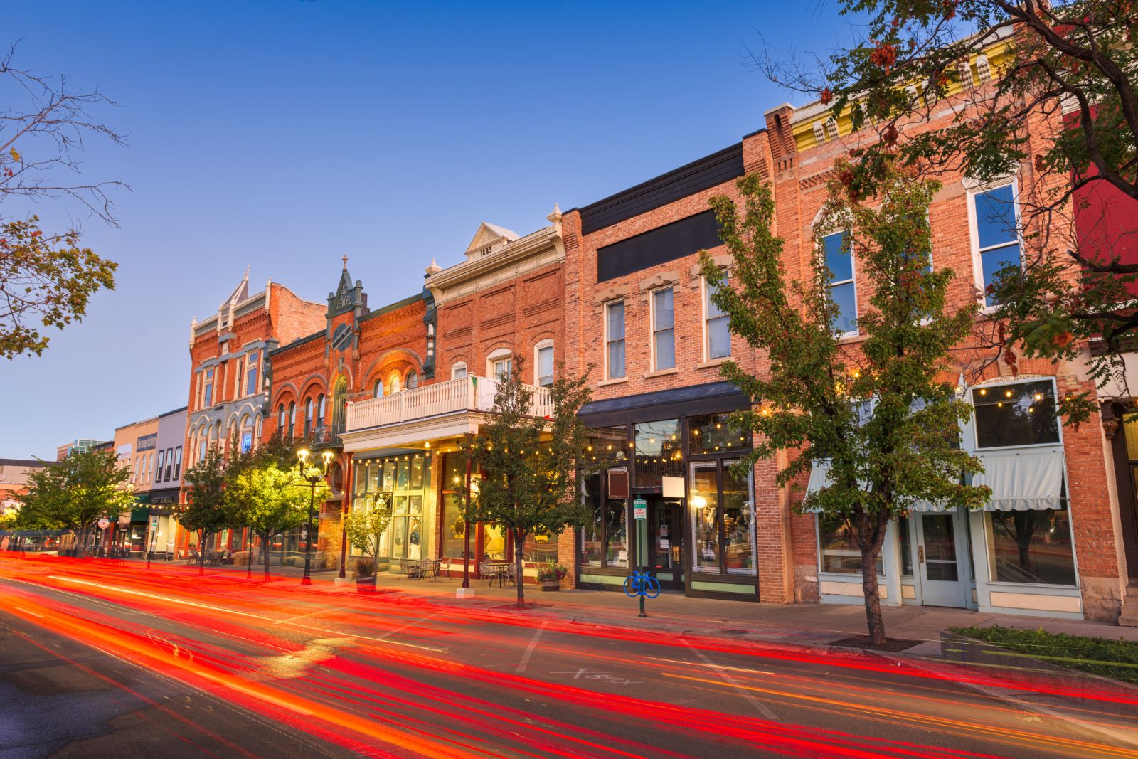 Small-town main street with local businesses at dusk